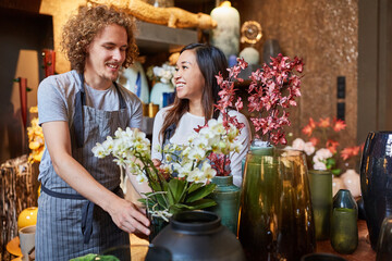 Florist and Asian colleague work as a team