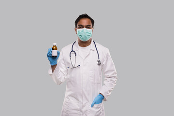 Indian Man Doctor Holding Cough Syrup Wearing Medical Mask and Gloves. Hands Wash Antiseptic....