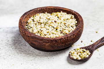 Peeled hemp seeds in a wooden bowl. Hemp - superfood, antioxidant, healthy supplement.
