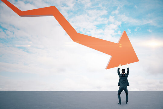 Businessman holding stock crash red arrow on cloud background.