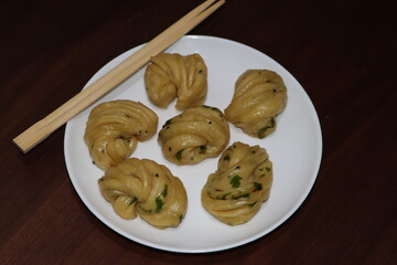 Steamed bread, typically made from wheat, prepared by steaming 