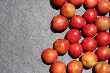 Fresh plum fruits on black background