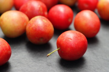 Fresh plum fruits on black background