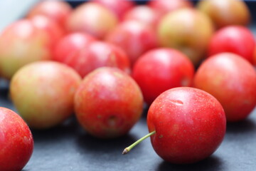 Fresh plum fruits on black background