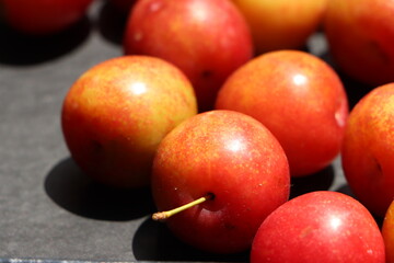 Fresh plum fruits on black background