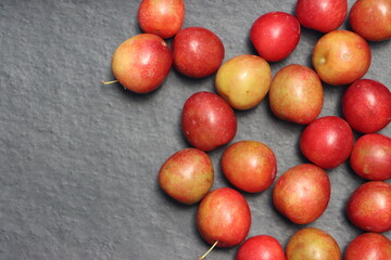 Fresh plum fruits on black background