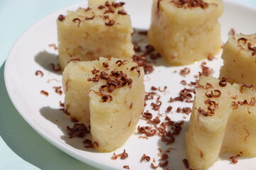 Suji Halwa or sheera, Indian sweet dish. Semolina dessert served in preety heart shape cake