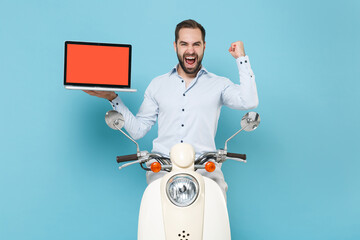 Happy bearded man guy in casual light shirt driving moped isolated on blue background. Driving...