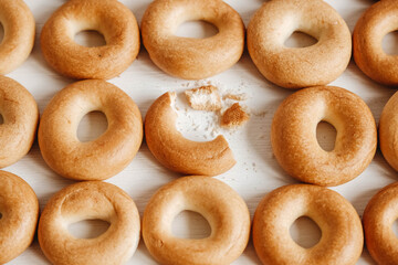 Drying or mini round bagels on a white wooden background. Top view. Copy, empty space for text