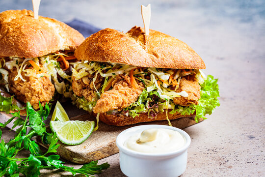 Crispy Fried Chicken Sandwiches With Coleslaw Salad On The Board.