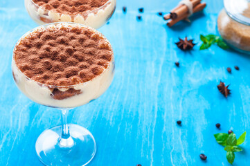 luxury tiramisu dessert in a cocktail glass decorated with cocoa