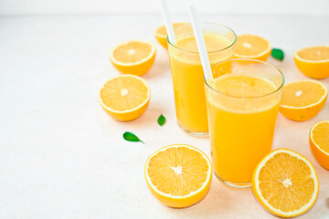 fresh orange Juice and oranges on the cutting board