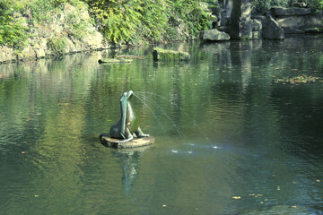 Gushing seal sculpture on a park pond.