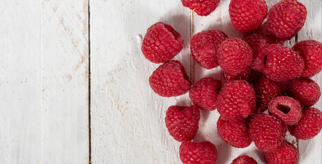 Ripe raspberry on white wooden background