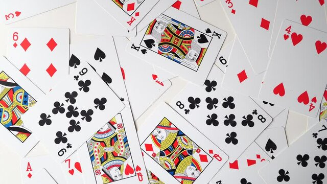 playing cards onto a white surface background.