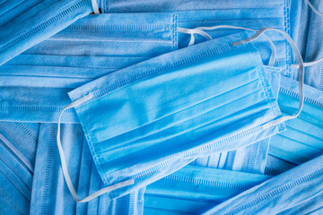 Stack of blue medical masks or paper masks.