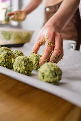 Lovely woman with beautiful hands cooking falafel in a modern kitchen. Healthy food, fitness, and sport diet concept.