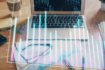 Financial graph colorful drawing and table with computer on background. Double exposure. Concept of international markets.
