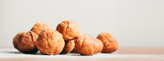 Bunch of baked donuts laying on the kitchen counter.