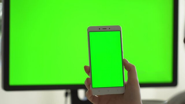 business woman using smartphone viewing green screen on mobile phone browsing chroma key online watching enjoying drinking coffee reading social media close up hands