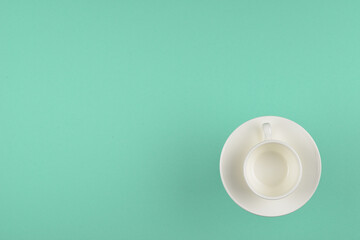 Empty cup on green background