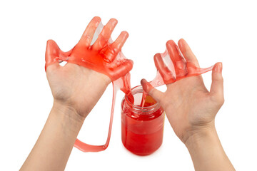 Red slime toy in woman hand isolated on white.