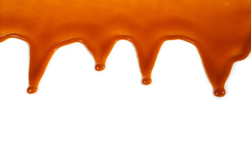 Background of flowing caramel sauce isolated on white.