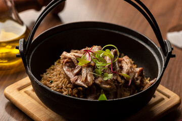 mushroom funghi duck rice risotto on a pan olive oil pepper in a pan