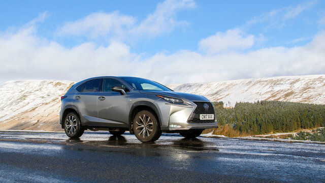 Brecon Beacons, UK: January 30, 2019: A Lexus NX 300h F-Sport Crossover Hybrid Car On The Road Side In Snow And Dangerous Icy Conditions With Natural Light And Blue Sky Background.