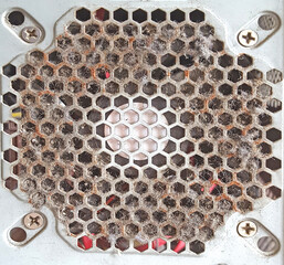 Old computer ventilation grill filled with dust and dirt