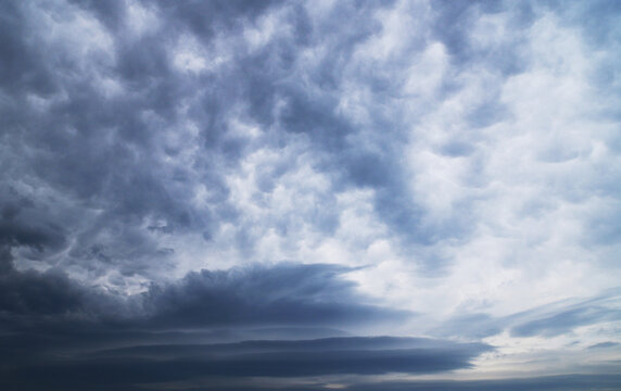 A picture showing two cloud formations. 
Asperitas clouds and Lenticular clouds.