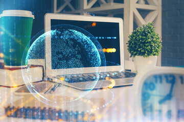 Double exposure of desktop with computer and world map hologram. International data network concept.