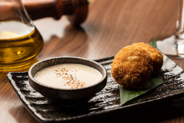 fried balls arancini stuffed with cheese and deep fried with sauce