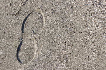Fototapeta na wymiar women shoe trace ( footprint ) on sand surface with copy space