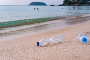 Plastic bottles abandoned on the beach. Ecology concept © Pattarisara