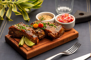 Ribs on barbecue on a wooden board with a blurred background