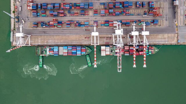 Timelapse of modern industrial port with containers from top view or aerial view. It is an import and export cargo port where is a part of shipping dock.