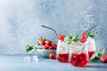 Red cocktail with ice and fresh strawberry