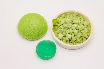 Sea salt, green tea soap and sponge isolated on white background