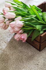 Beautiful pink tulip flowers in the wooden box