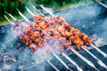 skewers on skewers cooked on the grill with smoke. outdoor grill at the cottage
