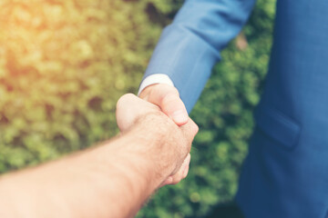 Congratulation to collaboration partner after sign on contract. Diverse Businessman shake hands together with businessman to introduce meeting. Trustworthy student friends meeting. Business Concept