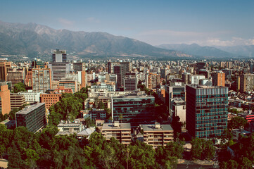 Skyline of modern buildings at financial district with The Andes mountain range in the back.
