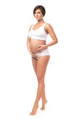 Young and beautiful pregnant woman on white background
