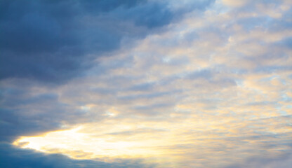 Naklejka na ściany i meble Nightly sky clouds background. Beautiful landscape with clouds and orange sun on sky