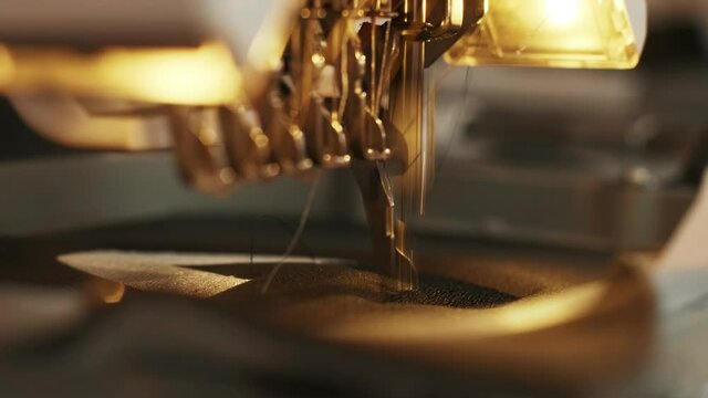 The automatic embroidery machine is working at high speed. Close-up