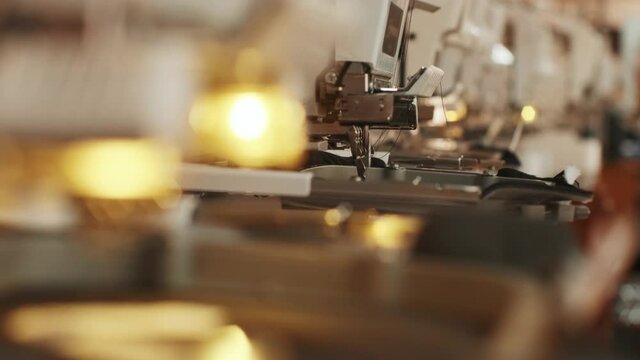 The automatic embroidery machine is working at high speed. Close-up