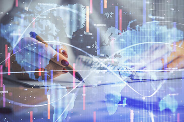 International business hologram over hands taking notes background. Concept of success. Multi exposure