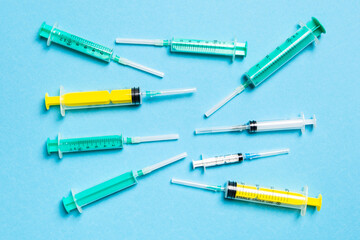 Top view of different syringes at blue background. Medical injection concept with copy space