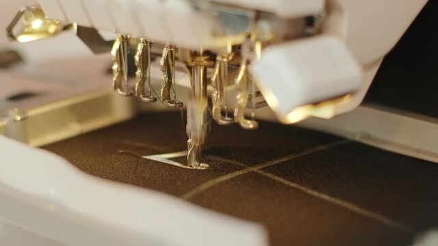 The automatic embroidery machine is working at high speed. Close-up